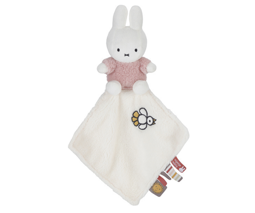 Miffy roosa kaisulapp lastetoas, asetatud voodile või tekile.