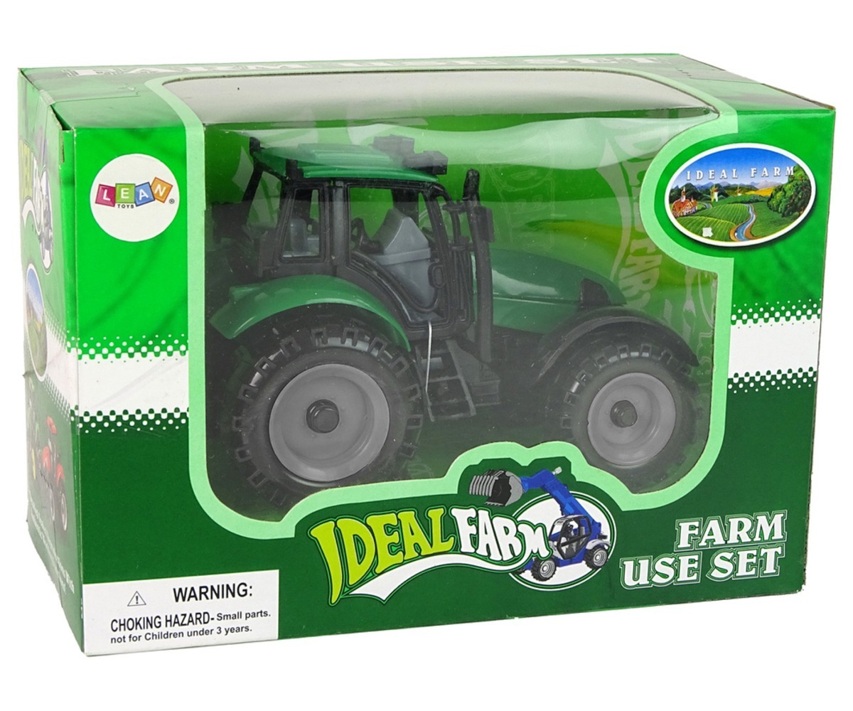 Traktor Ideal Farm Green avaneva kapotiga pakendis, mis sisaldab teavet ja hoiatusi turvalisuse kohta.