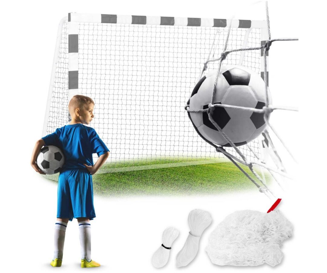 Poiss jalgpalliga seisab Neo-Sport jalgpallivärava võrgus, 215x150cm