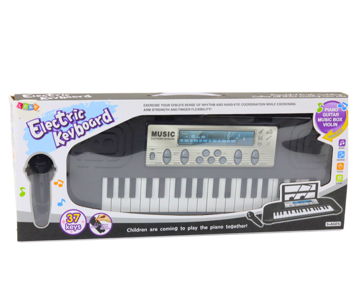 Laste süntesaator komplektina: süntesaator, mikrofon ja noodihoidja pakendis.