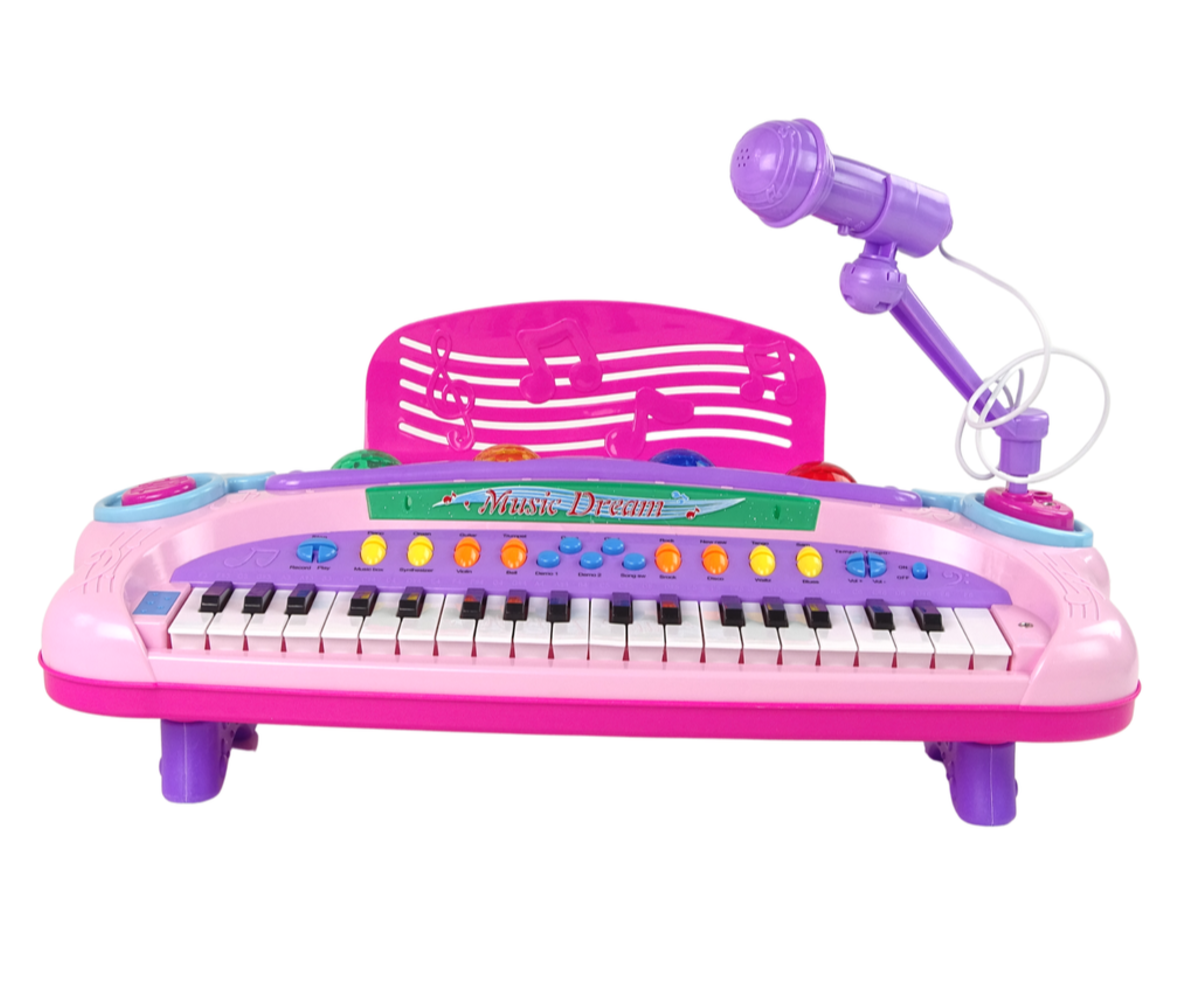Esiplaanilt nähtav laste süntesaator mikrofoniga 37 klahvi ja MP3 – roosa koos klahvide ja mikrofoniga.