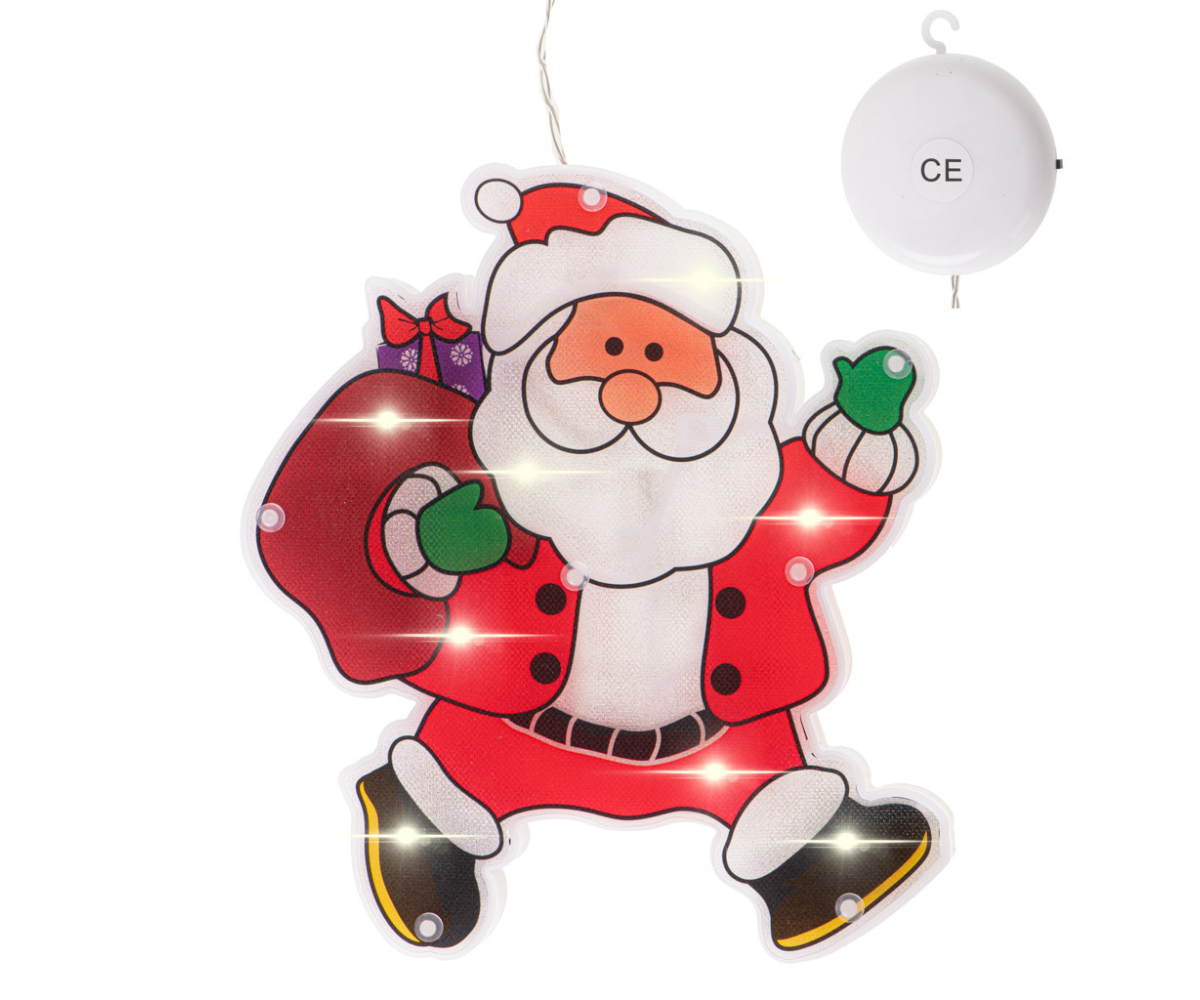 Akna külge kinnitatud Santa jõulukaunistus, soe valgus paistmas mõlemale poole.