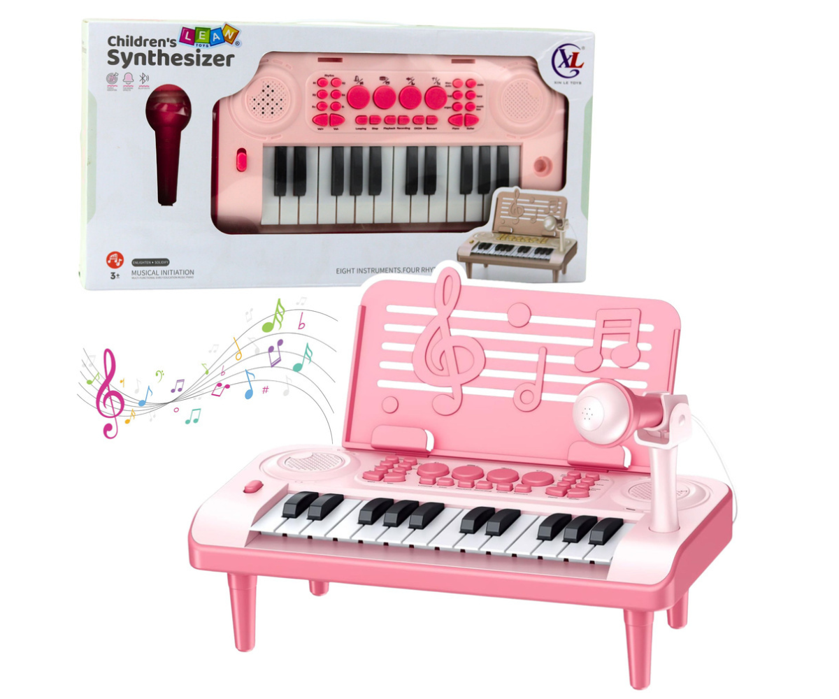 Roosa 24-klahviline laste klaver külgvaates koos mikrofoniga karaoke jaoks.