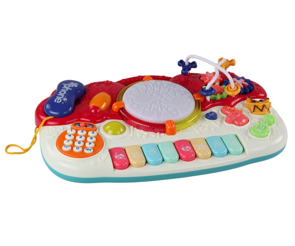 Laste hariv klahvpill trummi - helide ja valgusega, näidatud külgvaates, millel on helide aktiveerimise nupp.