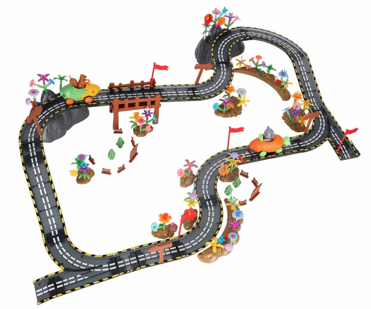 Magnetiline võidusõiduraja klotsikomplekt 310 osaga, mis näitab keerulisi rajakujundeid ja loodusmotiive.