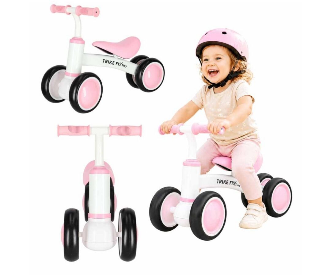 Laste naeratav tüdruk sõidab tasakaalurattaga Trike Fix Tiny V2 – roosa